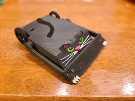 A 150 g flipper robot decorated as a black cat